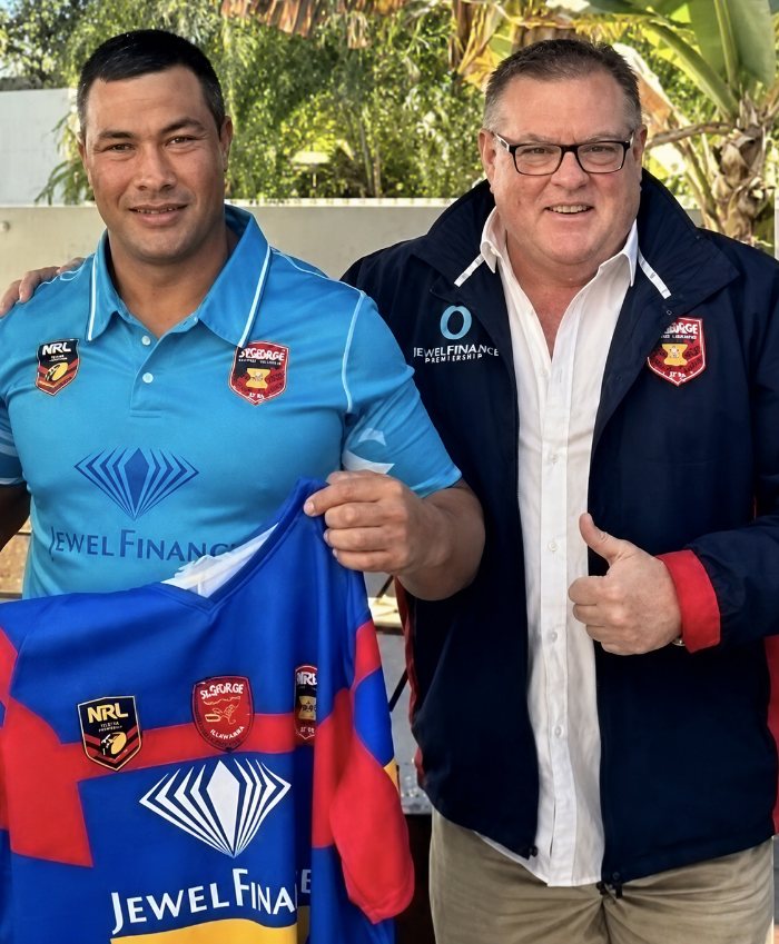 Carlin Millar holding a Jewel Finance sponsored rugby league jersey alongside David Francis