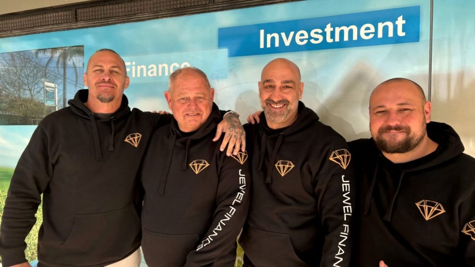 Four members of the Jewel Finance team outside their office